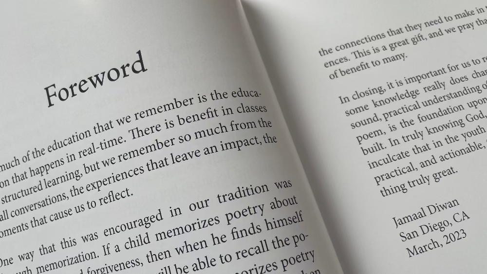 Open book with 'Foreword' section on a wooden surface