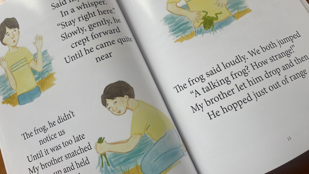 Open book with illustrations and text on a wooden surface